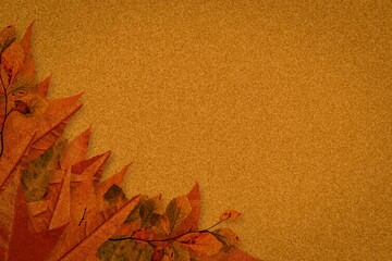 Cluster of dried autumn leaves is resting on flat design textured golden-brown backdrop, copy space