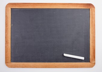 Chalkboard with piece of chalk