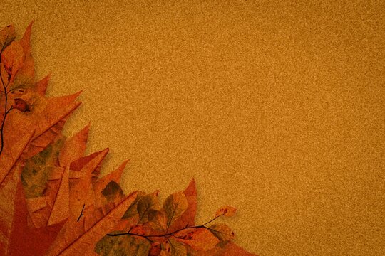 Fototapeta Cluster of dried autumn leaves is resting on flat design textured golden-brown backdrop, copy space