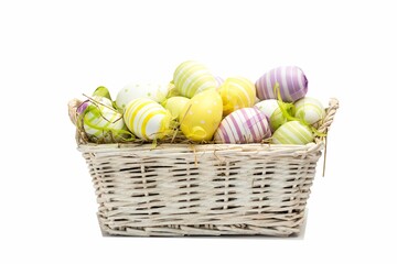 Vector wicker basket sitting on white bg with straw, pastel striped dotted eggs ribbons, copy space