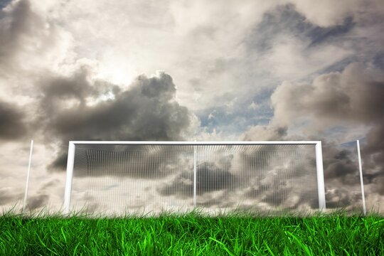 Fototapeta Football goal under grey cloudy sky