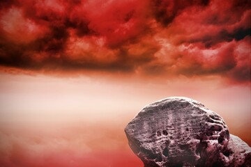 Large rock overlooking red sky