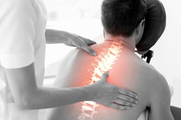 Highlighted spine of man having massage