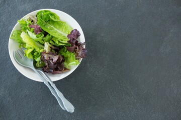 Fresh salad in bowl on stone tray