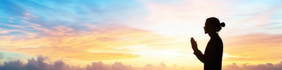 Person Silhouette Meditates Peacefully at Sunrise with Golden Sky at Dawn.