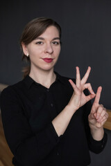 Woman showing the word goal in Russian sign language. 
