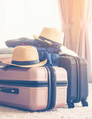 Close up suitcases and travel essentials being packed into bags.