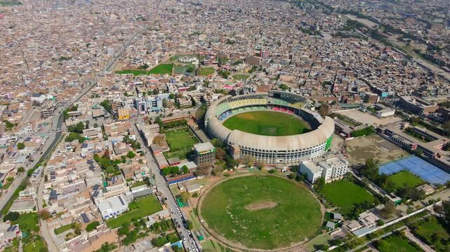 Aerial view of urban area with stadium and houses, Pakistan.