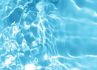 Abstract blurred shades of blue water background. Light and shadow ripples or splashes surface of water texture. Water waves with shining and reflection pattern photography for​ design artwork.