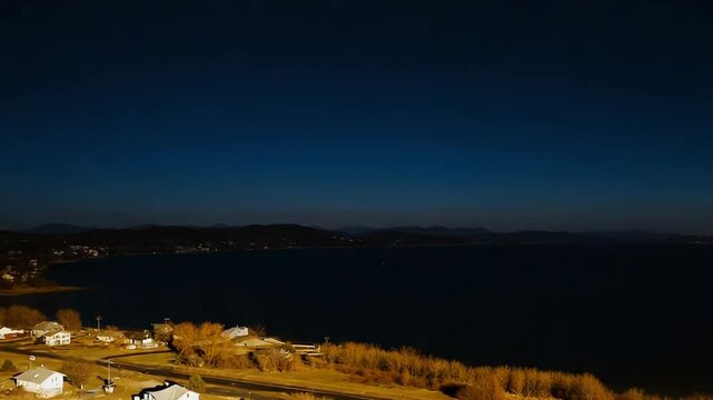 Aerial view of lake memphremagog stretching towards the horizon under a clear blue sky