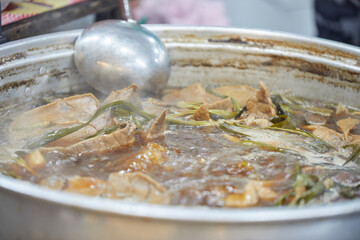 Spicy and sour beef offal soup in pot