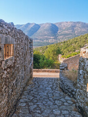 Houses ruines in Drakopoulata, abandonned village in Kefalonia after an earthquake with a panoramic mountain view, hidden gem in Kefalonia island, Greece