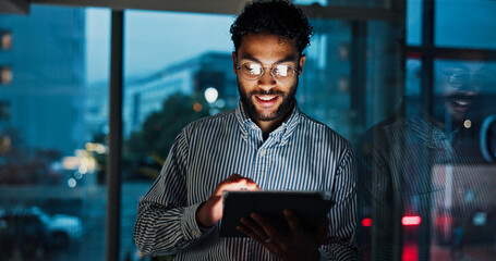 Tablet, research and businessman in office at night analyzing stock market by window for trading....