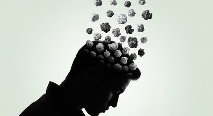 Silhouette of Person with Crumpled Paper Balls Falling Into Head in Artistic Concept