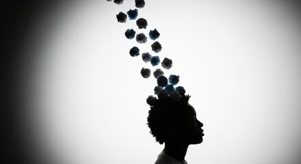Silhouette of Woman with Head Filled with Floating Blue and Black Pebbles in Bright Studio Setting
