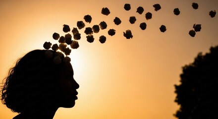 Silhouette of Woman with Flowing Hair Tossing Flowers Against Sunset Sky