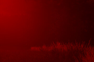 The scene features a vibrant red background that is filled with a significant amount of smoke...