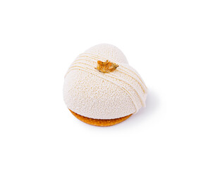 Delicate dessert showcasing smooth white frosting and golden leaf decoration