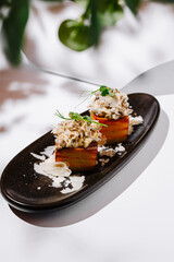 Unique culinary creation featuring layered savory dish on elegant plate