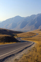 A winding road through a dry landscape with mountains in the background. The scene captures the beauty of nature and the serenity of rural travel.