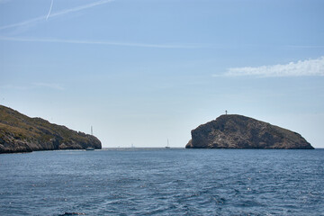 Boat trip through the Calanques of Marseille with blue waters and rock formations under a clear Mediterranean sky