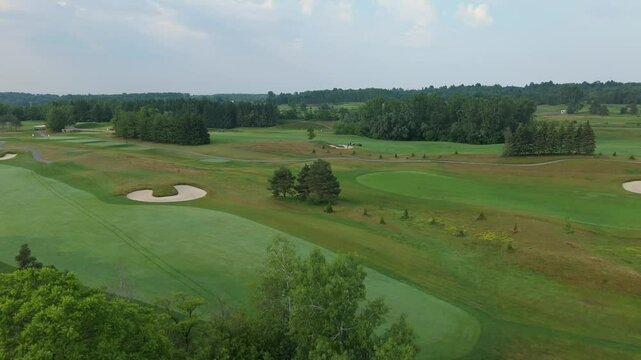 TPC Toronto fairways and manicured grass in Caledon, Canada, aerial reveal