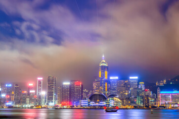 Hong Kong Skyline Illuminated at Night with Reflections in Victoria Harbour