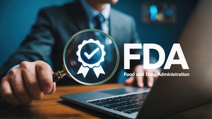 Businessman verifies FDA compliance using magnifying glass on laptop