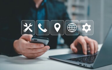 Person using laptop and mobile for technical support and contact information.
