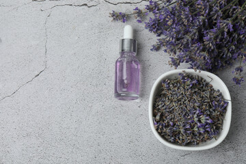Bottles of lavender oil, lavender on marble background