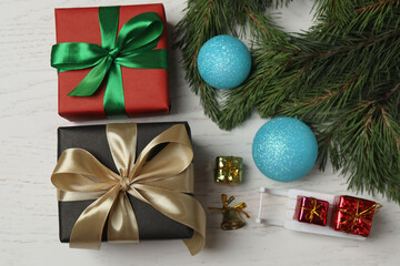 Gift boxes, New Year toys, New Year tree on white wood