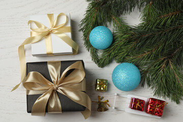 Gift boxes, New Year toys, New Year tree on white wood