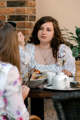 Woman talking during brunch outdoor cafe scene