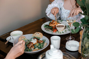 Women eating brunch at cozy cafe table