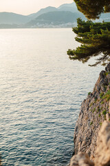 Serene Coastal Sunset with Rocky Cliffs