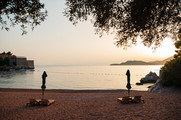 Serene Beach Sunset with Empty Loungers