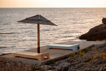 Sunset Loungers on Rocky Beach