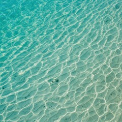 Clear Turquoise Water with Sun Reflections on Sandy Bottom