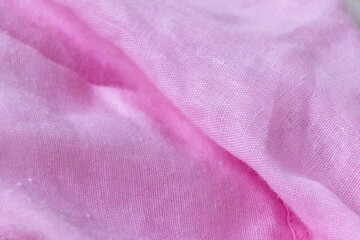 Close-up of rose pink cotton fabric draped with luxurious folds and smooth texture. Soft clothing...