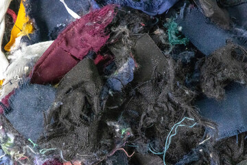 Close-up of recycled textile fibers texture background. These sustainable fibers are from torn cotton clothes and old garment fabric, repurposed for pillows, cushions, toys, and other products.