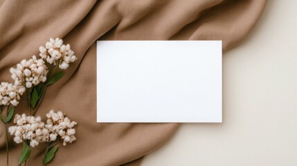 Obraz premium A white card is on a brown cloth with flowers