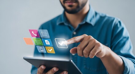 Digital Canvas A modern man in a blue shirt interacts with glowing app icons on a sleek tablet set against a soft grey