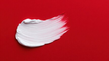 A white brush stroke on a red background
