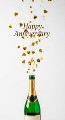 Champagne bottle with golden hearts for a happy anniversary celebration