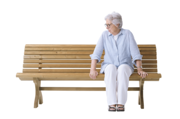 An elderly woman sitting on a bench is looking at the empty space beside her, symbolizing loneliness and grief.