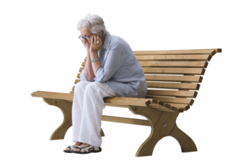 Elderly Woman Alone and Sad Sitting on a Bench, Holding Her Head in Her Hands. Concept of Depression.