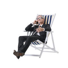 Manager in a black suit talking on the phone while sitting on a beach chair, isolated on a neutral...