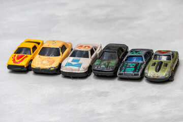 Collection of diverse old metal toy cars in various colors, showing visible discoloration and...