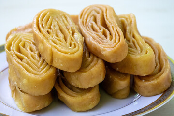Delicious Gaja sweet stack close-up texture with blur background. This traditional Khaja, Khajuri,...