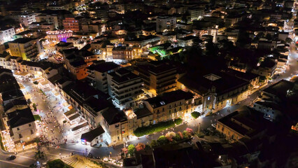 Obraz premium Aerial night view of Tropea town and coastline illuminated during summer from a drone